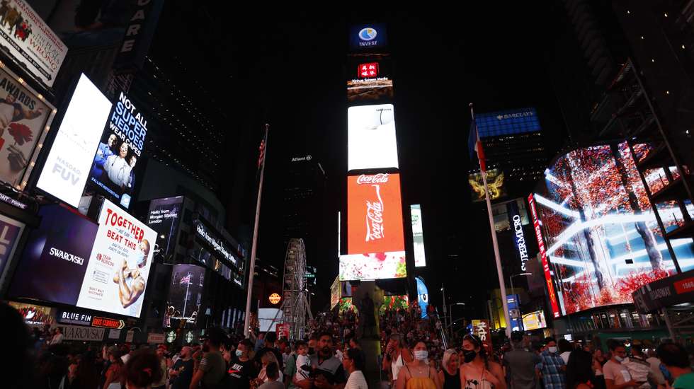 epa09429723 A general view of Times Square and the 110 feet (33.5 meters) tall Times Square Wheel, a ferris wheel which was constructed in Times Square in New York, New York, USA, 25 August 2021. The attraction will operate until 12 September.  EPA/JASON SZENES