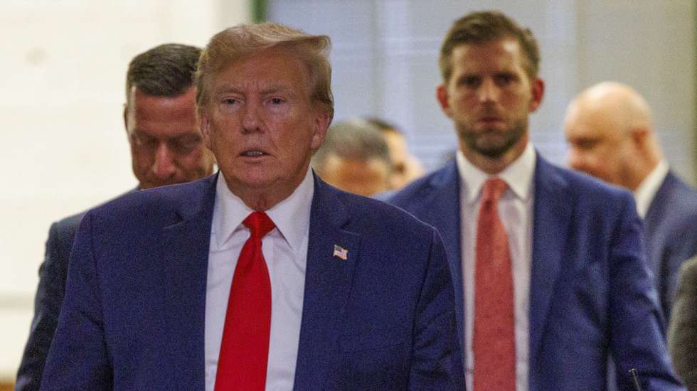 epa11016172 Former President of the United States, Donald J. Trump (L), exit the courtroom to speak to the press followed by his son, Eric Trump (R), during a break of his civil fraud court trial in New York, New York, USA, 07 December 2023. Trump, his adult sons and the Trump family business are facing a lawsuit by the State of New York accusing them of inflating the value of assets to get favorable loans from banks.  EPA/SARAH YENESEL
