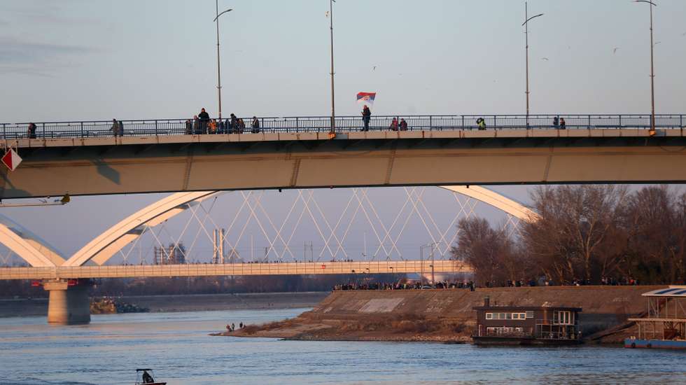 epa11868572 A protester waves a Serbian flag while participating in a blockade of the Varadinski bridge in Novi Sad, Serbia, 01 February 2025. University students staged a protest on the three-month anniversary of the Novi Sad railway station collapse, demanding accountability for the tragedy that claimed 15 lives on 01 November 2024. The station, which had been renovated and reopened on 05 July 2024, was undergoing additional renovations shortly before the collapse.  EPA/ANDREJ CUKIC