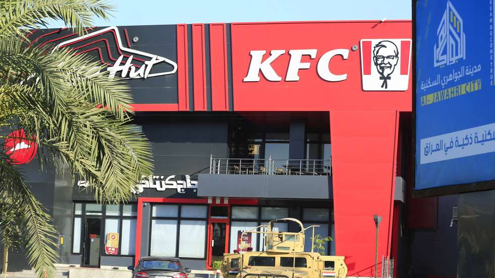 epa11389740 An Iraqi military armored truck is stationed in front of a KFC resturant at the Al-Jadriyah district in Baghdad, Iraq, 04 June 2024. Iraqi forces imposed tight security measures around restaurants, after dozens of militants attacked two restaurants in Baghdad late on 03 June 2024 including a KFC resturant, security officials said, amid increasing calls to boycott US brands over war in Gaza.  EPA/AHMED JALIL
