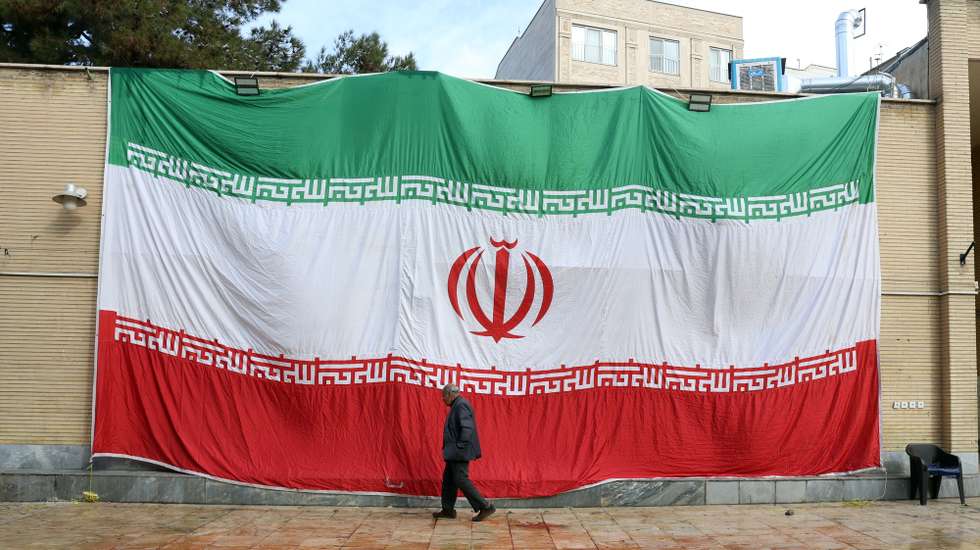 epa12667188 A huge Iranian national flag hangs from the wall of a mosque which was damaged by fire during recent anti-government protests, in Tehran, Iran, 21 January 2026. Iran is experiencing a nationwide internet blackout that began on 08 January 2026, amid an intensifying wave of anti-government protests.  EPA/ABEDIN TAHERKENAREH