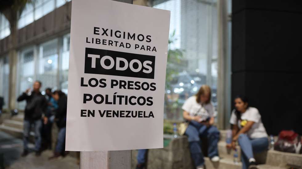 epa12639476 A sign taped to a beam is seen outside of El Helicoide in Caracas, Venezuela, 09 January 2026. El Rodeo I, Tocoron, Ramo Verde, El Helicoide and Yare II prisons hold most of the political prisoners in Venezuela, according to the NGO Foro Penal, which reported that several detainees have been released.  EPA/MIGUEL GUTIERREZ