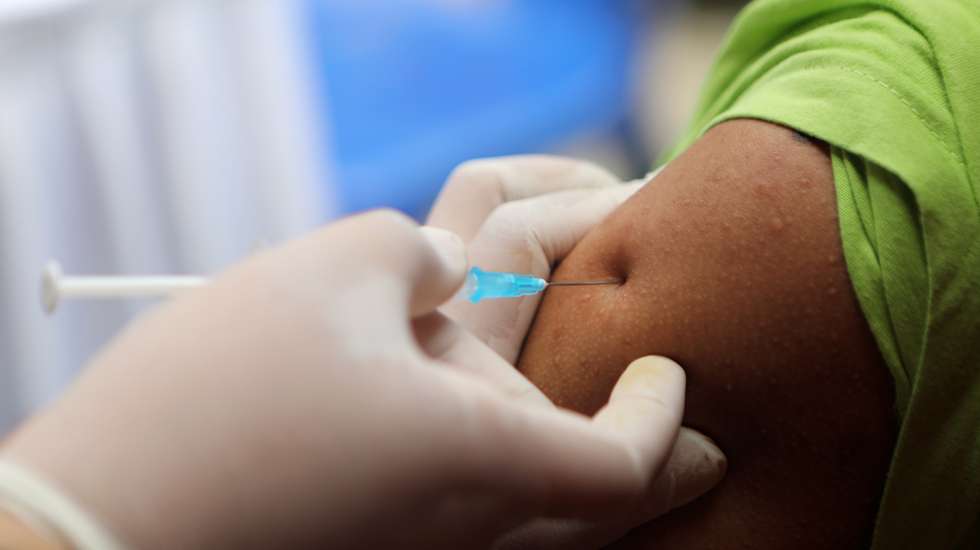 epaselect epa09345412 A woman receives a dose of Sinovac vaccine during a mass vaccination for locals in Banda Aceh, Indonesia, 15 July 2021. Indonesia is speeding its vaccination program as the number of COVID-19 cases reach over 2,600,000 since the beginning of the pandemic.  EPA/HOTLI SIMANJUNTAK
