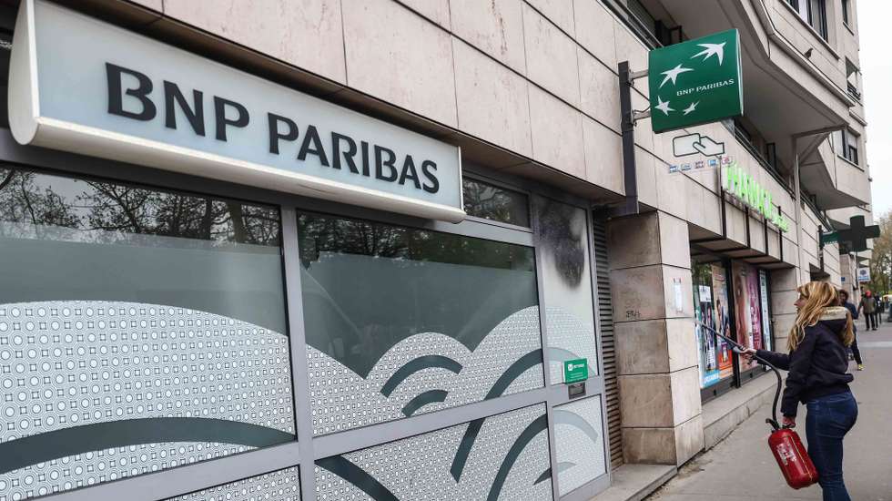 epa10567267 An activist from Extinction Rebellion environmental movement spray paints a branch of BNP Paribas as they denounce the East African Crude Oil Pipeline (EACOP) project of TotalEnergies in East Africa, in Paris, France, 10 April 2023. Activists from Extinction Rebellion movement protest against BNP Paribas, as they concider it as a major financial partner of TotalEnergies, and therefore participating in the financing of the East African Crude Oil Pipeline (EACOP) crossing several African countries.  EPA/Mohammed Badra