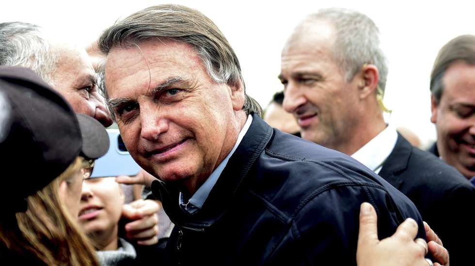 epa10706438 Former Brazilian President Jair Bolsonaro (C) is received by supporters in Porto Alegre, Rio Grande do Sul, Brazil, 22 June 2023. The Superior Electoral Court of Brazil opened on 22 June in Brasilia the first hearing of a trial in which it will analyze the alleged abuses committed by former President Jair Bolsonaro during the campaign for the 2022 October elections. The far-right leader is accused of abusing his position as head of state to promote his candidacy and maintain a harsh discredit campaign against the electoral Justice itself and democratic institutions.  EPA/RICARDO RIMOLI