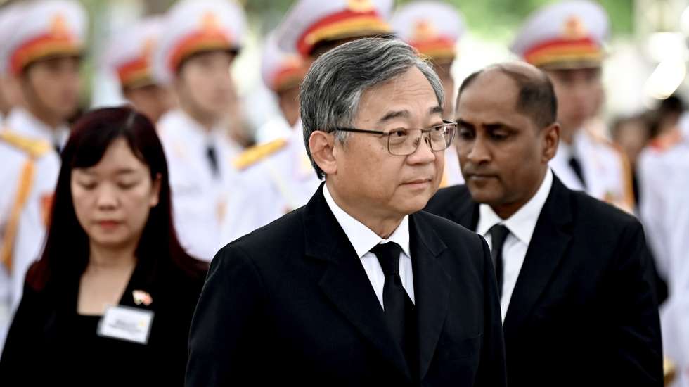 epa11495357 Deputy Prime Minister of Singapore Gan Kim Yong (R) pays his respect for the late General Secretary of the Communist Party of Vietnam Nguyen Phu Trong at the national funeral house on the first day of national mourning in Hanoi, Vietnam, 25 July 2024. Vietnam holds a two-day national funeral on 25 and 26 July for General Secretary of the Communist Party, Nguyen Phu Trong, who died in Hanoi on 19 July at the age of 80.  EPA/NHAC NGUYEN / POOL