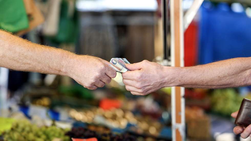 epa10843379 A customer pays for their purchase at a weekly market, in Essen, Germany, 06 September 2023. According to German government's statistics, food prices in July 2023 were on average 11 percent higher compared to the same period in 2022. German welfare organizations reported in 2022 that 13.8 million people in Germany lived in poverty or were at risk of being below the poverty line.  EPA/CHRISTOPHER NEUNDORF