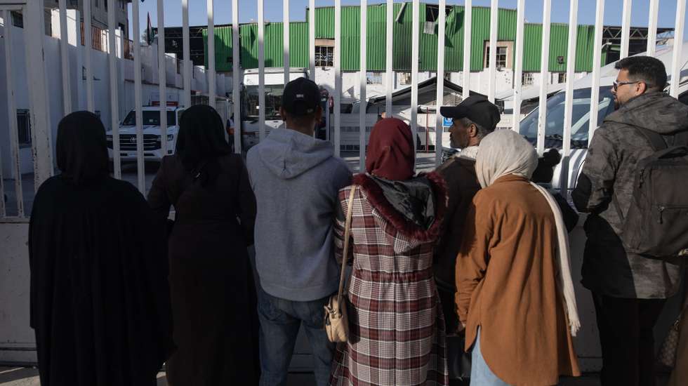 epa12888256 People stand at the Red Crescent headquarters before transporting injured Palestinians toward the Rafah land crossing for transfer abroad to receive medical treatment in Khan Younis, southern Gaza Strip, 14 April 2026. The WHO said it resumed medical evacuations from Gaza on 12 April after the process was suspended on 6 April following a security incident in which a person contracted to provide services to WHO in Gaza was killed.  EPA/HAITHAM IMAD