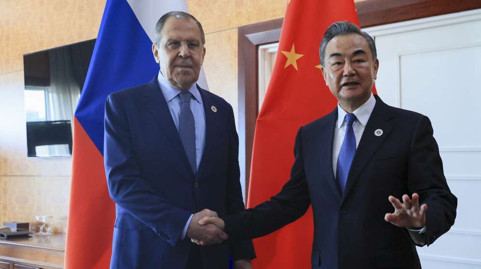 epa10106755 A handout photo made available by the Russian Foreign Ministry press service shows Russian Foreign Minister Sergei Lavrov (L) and Chinese Foreign Minister Wang Yi (R) shaking hands during a bilateral meeting on the sidelines of the East Asia Summit Foreign Ministers' Meeting in Phnom Penh, Cambodia, 05 August 2022. Cambodia is hosting the 55th ASEAN Foreign Ministers' Meeting (AMM) and related meetings from 31 July to 06 August 2022.  EPA/RUSSIAN FOREIGN MINISTRY PRESS SERVICE HANDOUT  HANDOUT EDITORIAL USE ONLY/NO SALES