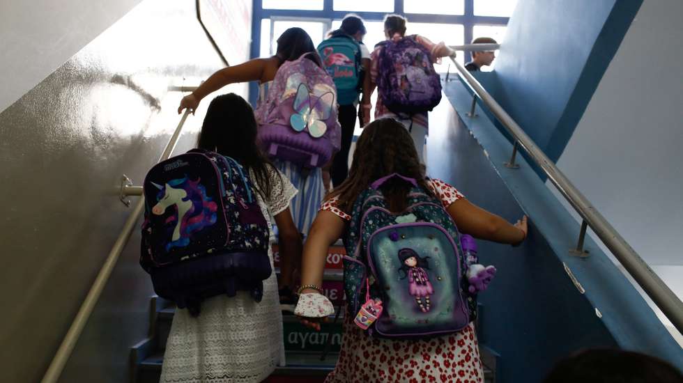 epa10179449 Students of a primary school walk towards their clas room during the first day of the new school year, in Piraeus, Greece, 12 September 2022. Schools in Greece reopen on 12 September for the start of a new academic year, with roughly 1.34 million school children of all ages attending. The measures against Covid-19 will be greatly relaxed, with the use of masks made optional, while pupils that show symptoms are required to remain home.  EPA/YANNIS KOLESIDIS