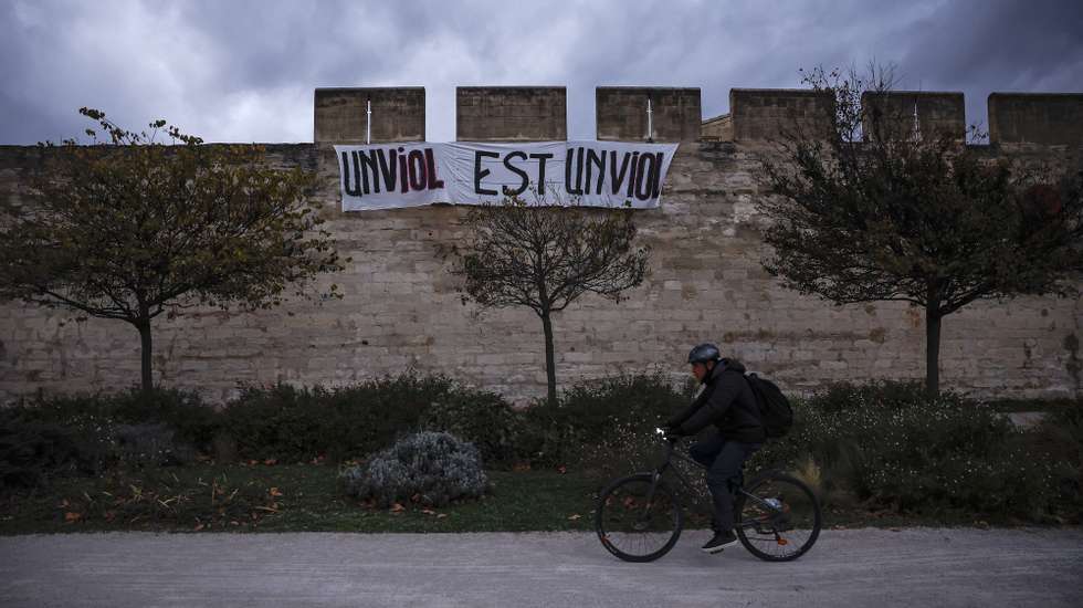 epa11739301 A banner reading 'a rape is a rape' is displayed in front of  the criminal court in Avignon, France, 25 November 2024, during the trial of Gisele Pelicot's ex-husband Dominique Pelicot, accused of drugging and raping his then-wife. He is also accused of inviting dozens of men to rape her while she was unconscious at their home in Mazan, France, between 2011 and 2020. Fifty other men are facing trial for their alleged involvement. Dominique Pelicot could face a maximum sentence of 20 years in prison if convicted.  EPA/YOAN VALAT