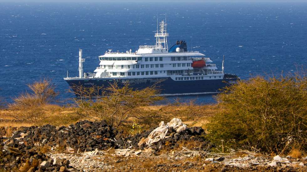epa12931927 Dutch cruise ship MV Hondius (back) is anchored off the coast of the city of Praia on the island of Santiago, Cape Verde, 04 May 2026, after three people died onboard from an acute respiratory syndrome. The World Health Organization (WHO) reported one confirmed case and five additional suspected cases of hantavirus infection on the vessel sailing in the Atlantic Ocean. Three of those affected have died and one is currently in intensive care in South Africa.  EPA/ELTON MONTEIRO