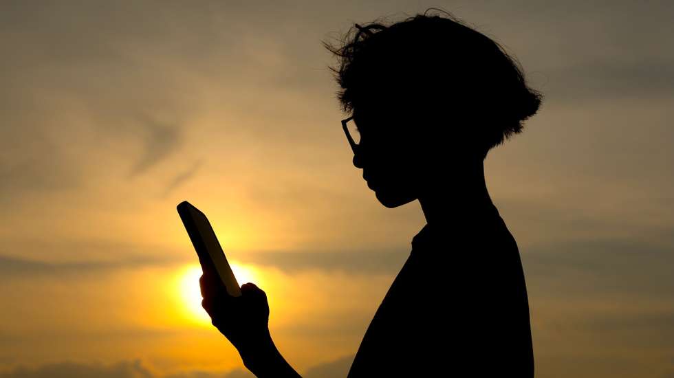 epa13008796 A silhouette of a child looking on his mobile phone in Putrajaya, Malaysia, 01 June 2026. Malaysia's new Child Protection Code (CPC) under the Online Safety Act 2025 (ONSA) takes effect on 01 June for major social media platforms operating in the country, including Facebook, Instagram, YouTube and TikTok, barring children under 16 from opening new accounts and implementing age verification, privacy and safety settings, content moderation, recommendation algorithms, parental control tools and restrictions on harmful or exploitative interactions.  EPA/FAZRY ISMAIL