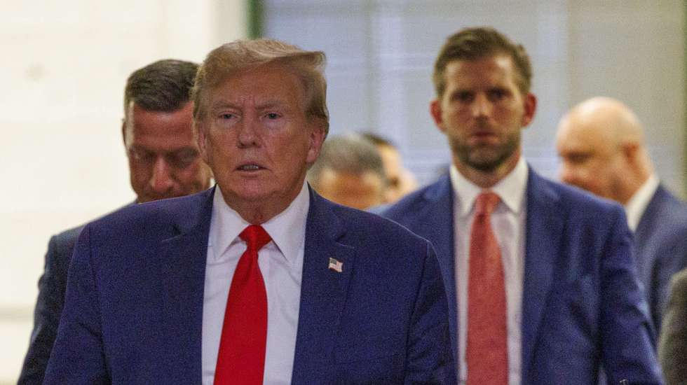 epa11016172 Former President of the United States, Donald J. Trump (L), exit the courtroom to speak to the press followed by his son, Eric Trump (R), during a break of his civil fraud court trial in New York, New York, USA, 07 December 2023. Trump, his adult sons and the Trump family business are facing a lawsuit by the State of New York accusing them of inflating the value of assets to get favorable loans from banks.  EPA/SARAH YENESEL