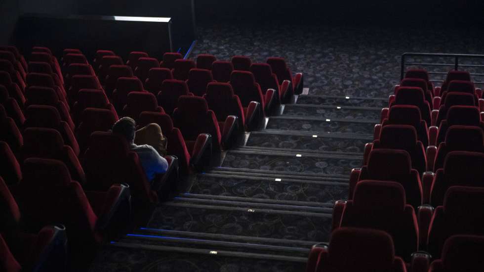 epa08289915 A sole spectator watches a film at a movie theatre in Budapest, Hungary, 12 March 2020. Effective of 12 March, cinemas are restricted to sell a maximum of 99 tickets for a show as on the previous day the Hungarian government declared a state of emergency in response to the novel coronavirus, and prohibited all indoor events with more than 100 participants and outdoor events attended by more than 500 participants. Three more cases have emerged in Hungary on 12 March 2020, bringing the number of confirmed cases of Covid-19 in the country to 16, including nine Iranian, six Hungarian and one British citizens.  EPA/Marton Monus HUNGARY OUT