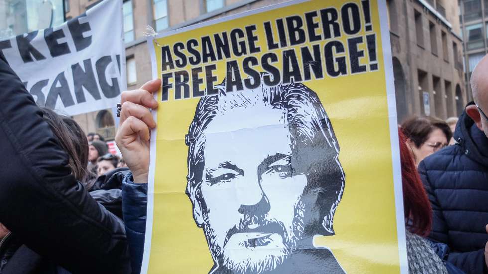 epa11168291 Pro-Assange campaigners shows signs during a protest at the British Consulate in Milan, Italy, 20 February 2024. Julian Assange is facing his final extradition hearing at the High Court on 20 to 21 February in London. Assange is facing 175 years in a US prison if the hearing goes against him.  EPA/MATTEO CORNER