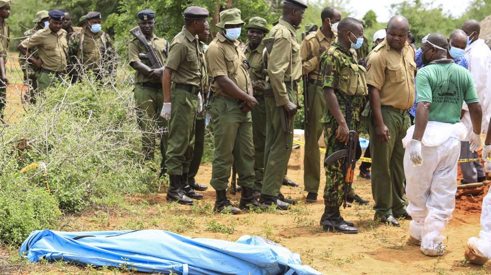 epa10588063 Kenyan homicide detectives and forensic experts from the Directorate of Criminal Investigations (DCI), examine exhumed bodies from several shallow mass graves of suspected members of a Christian cult after starving themselves to death, after allegedly being told by their controversial preacher Paul Mackenzie that they would go to heaven if they starved themselves to death, in the coastal Shakahola forest, in Kilifi, Kenya, 23 April 2023. According to the Police, 18 more bodies were exhumed on 23 April bringing the tally of bodies recovered to at 39.  EPA/STR