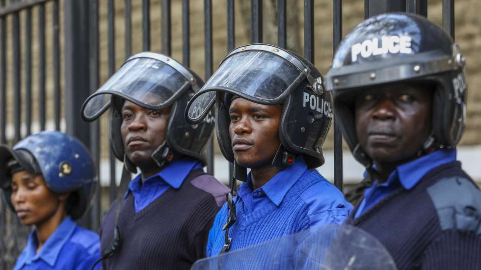 epa11345056 Kenyan anti-riot police officers stand guard as activists and members of the Nairobi professionals and residents group protest against unplanned development projects, in Nairobi, Kenya, 16 May 2024. The protesters claim that the unplanned development projects and corruption has led to devastating consequences for community’s safety, including the recent flooding in the capital, forced evictions and demolition of buildings said to be set on riparian land.  EPA/DANIEL IRUNGU