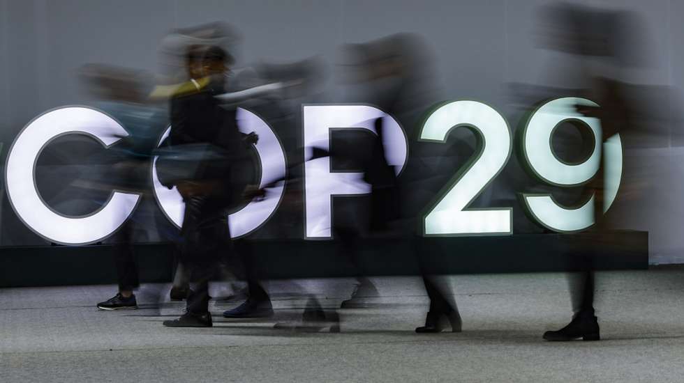 epa11730467 Participants pass light letters at the United Nations Climate Change Conference COP29 in Baku, Azerbaijan, 20 November 2024. The Azerbaijani capital of Baku hosts the 2024 United Nations Climate Change Conference (COP29) from 11 to 22 November 2024.  EPA/ANATOLY MALTSEV