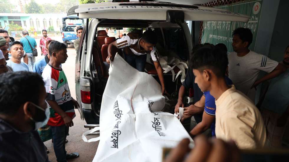 epa12850121 Bodies of the bus accident victims arrive at Rajbari Government Hospital, a day after a bus plunged into the Padma River while boarding a ferry in Rajbari district, 84 km from Dhaka, Bangladesh, 26 March 2026. At least 23 people were killed and several remain missing as search and rescue operations continue for the Dhaka-bound passenger bus after it plunged into the river on 25 March, according to police officials.  EPA/STR
