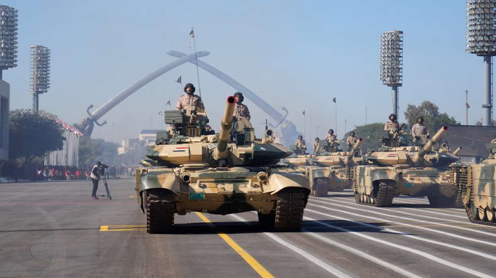 epa11061038 Iraqi soldiers aboard tanks take part in a parade marking the Iraqi Army's 103 anniversary in Baghdad's fortified Green Zone, Iraq, 06 January 2024.  EPA/HADI MIZBAN / POOL