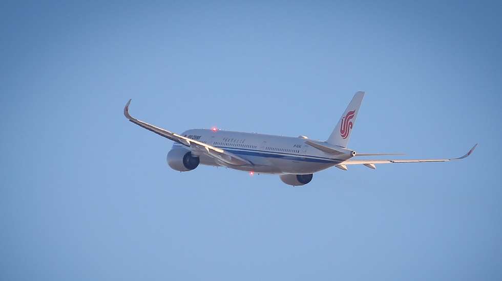 epa10394888 An Air China airplane flies over the Beijing Capital International Airport in Beijing, China, 08 January 2023. China has reopened its borders and no longer requires quarantine for inbound travelers. The country's National Health Commission (NHC) has downgraded the management of COVID-19 from Class A to Class B as part of measures in reopening the country.  EPA/MARK R. CRISTINO