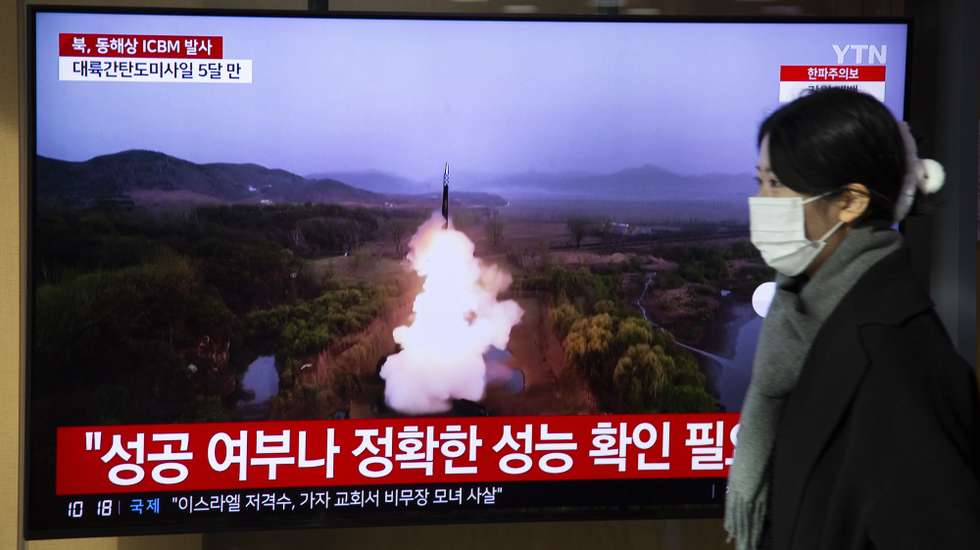 epa11035330 A woman watches the news at a station in Seoul, South Korea, 18 December 2023. According to South Korea's Joint Chiefs of Staff (JCS), North Korea launched an Intercontinental Ballistic Missile (ICBM) into the East Sea on 18 December.  EPA/JEON HEON-KYUN