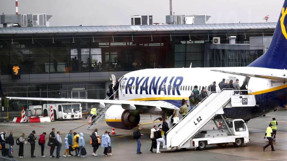epa11310202 Passengers board a Ryanair group airplane at Riga Airport, Latvia, 30 April 2024. Riga Airport is the international airport of Riga, the capital of Latvia, and the largest airport in the Baltic states.  EPA/TOMS KALNINS