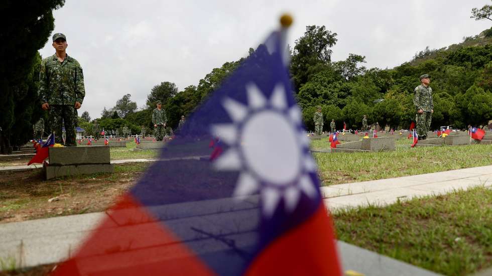 epa10814757 Taiwanese soldiers stand next to the tombstones of the fallen soldiers during the 65th Anniversary of the artillery battle between Taiwan and China, in Kinmen, Taiwan, 23 August 2023. Taiwan President Tsai Ing-wen visited Kinmen Islands near China to preside over a ceremony observing the 65th Anniversary of the Victory of the August 23rd artillery battle between Taiwan and China.  EPA/RITCHIE B. TONGO