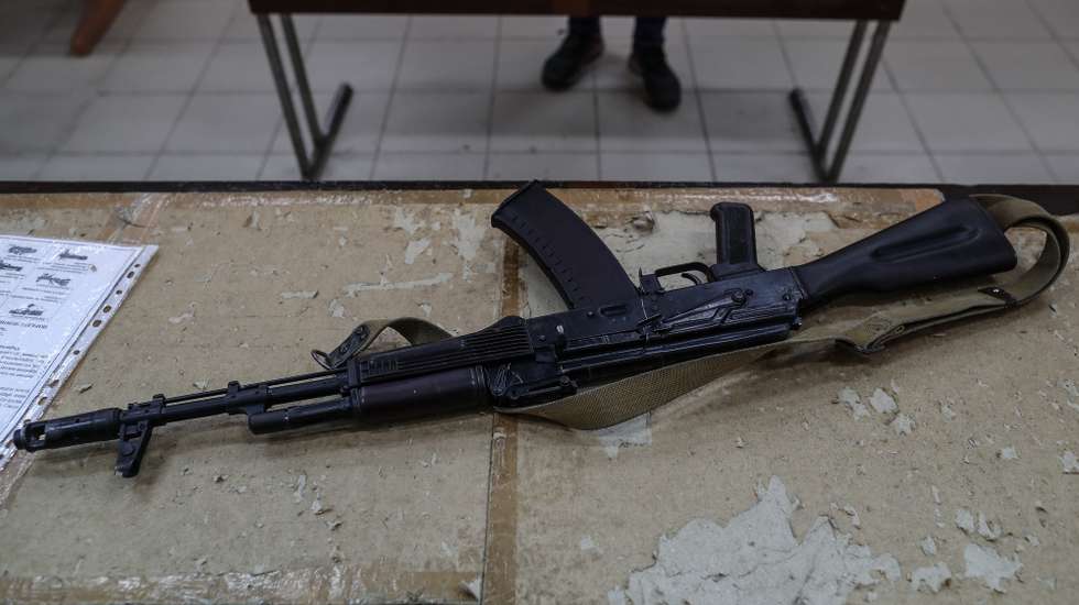 epa09840905 AK-47 rifle is seen on the table while locals of Odessa learn war tactics and how to handle weapons, in south Ukrainian city of Odesa, in Ukraine, 21 March 2022. Russian troops entered Ukraine on 24 February prompting the country's president to declare martial law and triggering a series of announcements by Western countries to impose severe economic sanctions on Russia.  EPA/SEDAT SUNA