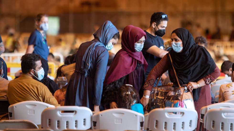 epa09438039 Afghan refugees are seen upon arrival at the Rota naval base in Cadiz, Spain, 31 August 2021. A US aircraft with 200 evacuees from Afghanistan on board landed at the Rota naval base in Cadiz on 31 August 2021.  EPA/Roman Rios