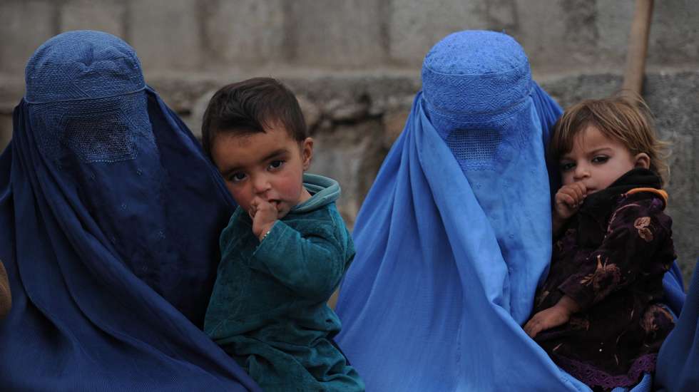 epa05195700 A picture made available on 05 March 2016 shows wives of two of the three brothers Ehsanullah, Habidullah and Rohullah who were killed in a suicide attack on 27 February, visiting their graves in Kunar, Afghanistan, 04 March 2016. Habidullah, Ehsanullah and Rohullah, the street vendors, were killed in the suicide attack in front of the provincial Governor's office in Kunar while their fourth brother was critically injured, some 14 people were killed in the incident while 50 were injured. The United Nations says more than 11,000 civilians were killed or wounded in violence in Afghanistan in 2015, making it the worst year for civilian casualties since the organization began compiling the statistics in 2009.  EPA/GHULAMULLAH HABIBI
