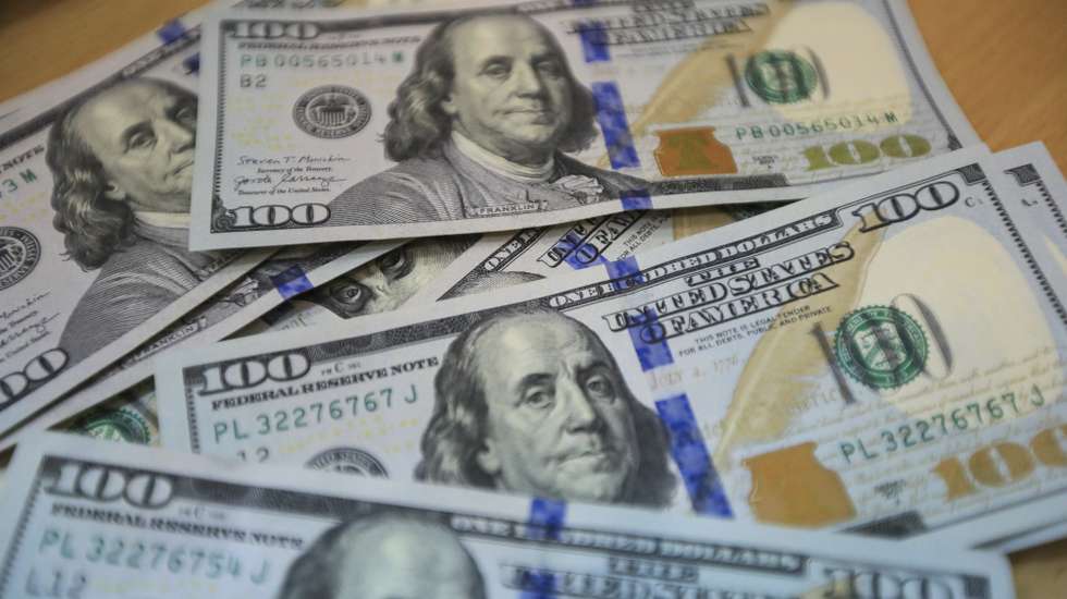 epa10210339 US dollar banknotes are displayed on a table at a money exchange company in Nairobi, Kenya, 27 September 2022. A worker points at the Euro currency exchange rate against the Kenyan shilling on a currency board at a money exchange company in Nairobi, Kenya, 27 September 2022.  EPA/Daniel Irungu