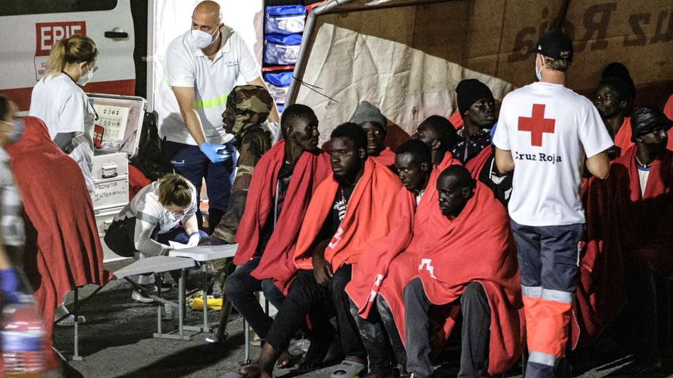 epa11156534 Red Cross staff members attend to migrants upon their arrival at the port of Las Palmas, Gran Canaria island, Spain, 15 February 2024. Spain's Maritime Rescue have rescued about 80 migrants who were traveling in a canoe off the northern coast of Gran Canaria.  EPA/ANGEL MEDINA G.