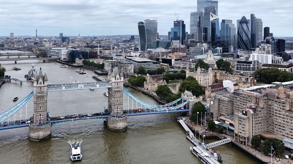 epa11550143 A picture taken with a drone shows the Tower Bridge and skyline of the financial district of the City of London in London, Britain, 15 August 2024.  According to the Office for National Statistics (ONS), Britain's economy grew by 0.6 percent between April and June 2024, slowing down compared to the first quarter. Services were the biggest contributor to the country's economy, outstripping both manufacturing and construction.  EPA/NEIL HALL