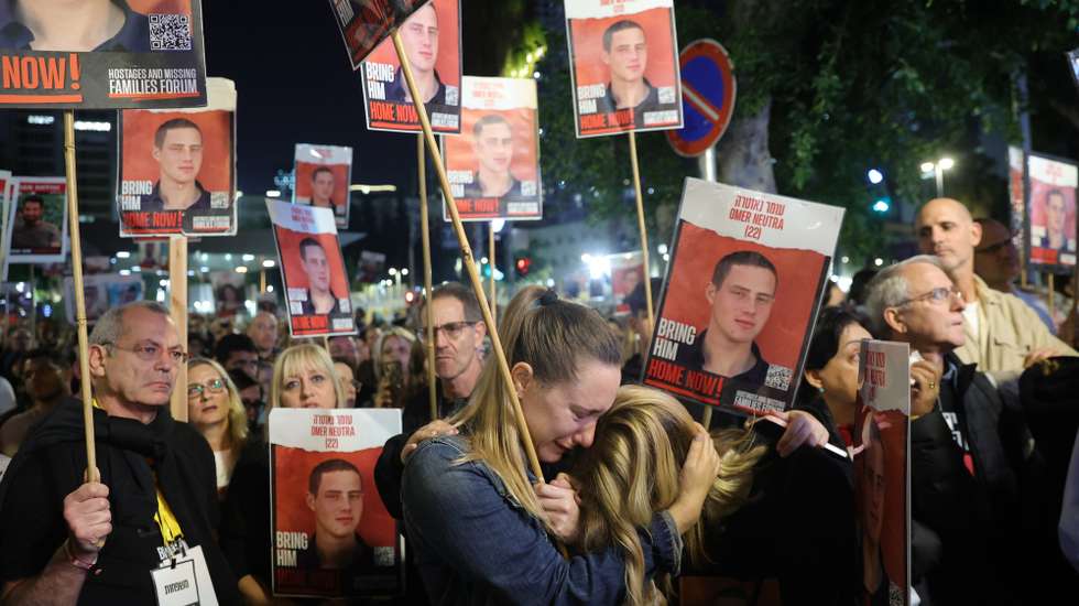 epa11072387 (FILE) - epa11049801 Women embrace as they join people holding pictures of hostages held by Hamas in Gaza during a protest outside the Kirya military base in Tel Aviv, Israel, 30 December 2023. (Issued 12 January 2024). Upcoming 14 January 2024 will mark the one-hundredth day since Hamas' attack on Israel. More than 23,600 Palestinians and at least 1,300 Israelis have been killed, according to the Palestinian Health Ministry and the Israel Defense Forces (IDF), since Hamas militants launched an attack against Israel from the Gaza Strip on 07 October, and the Israeli operations in Gaza and the West Bank which followed it.  EPA/ABIR SULTAN