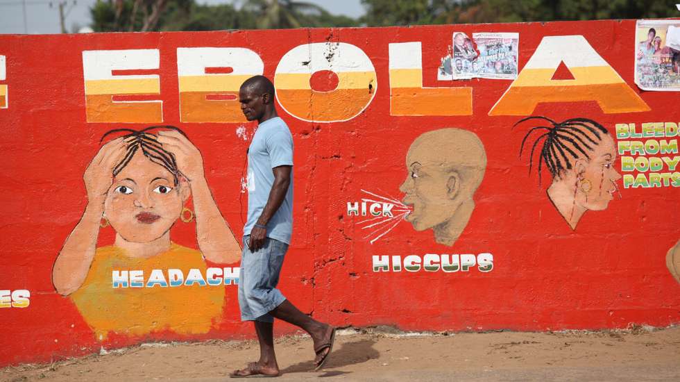 epa12923451 (FILE) - A Liberian man walk pass an ebola awareness painting on a wall in downtown Monrovia, Liberia, 22 March 2015 (reissued 30 April 2026). WHO's World Immunisation Week is celebrated during the last week of April to raise awareness of the importance of vaccines. This year, the focus is not only on childhood vaccines but also on immunisation throughout life, with an emphasis on adult vaccines, protection against ageing, and preventive care.  EPA/AHMED JALLANZO *** Local Caption *** 51856218