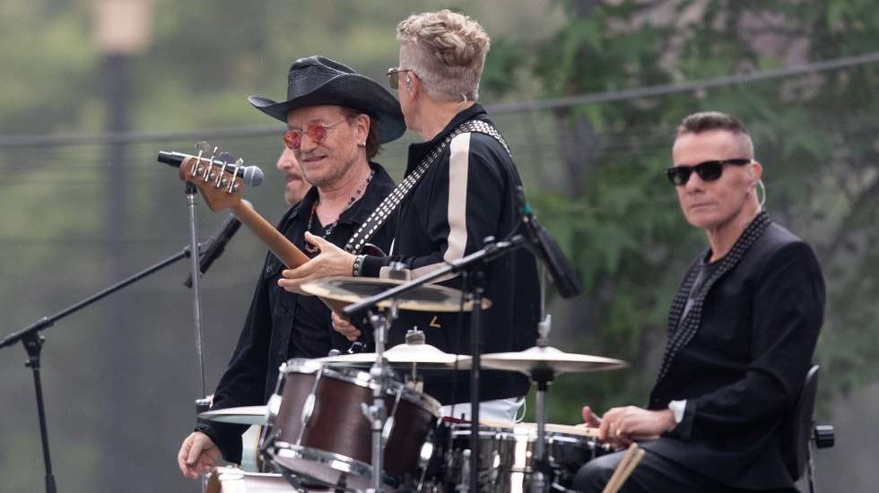 epa12952105 (L-R) U2 members Bono, Adam Clayton, and Larry Mullen Jr. film the music video for the song 'Street of Dreams' in Mexico City’s Historic Center in Mexico City, Mexico, 12 May 2026.  EPA/Madla Hartz