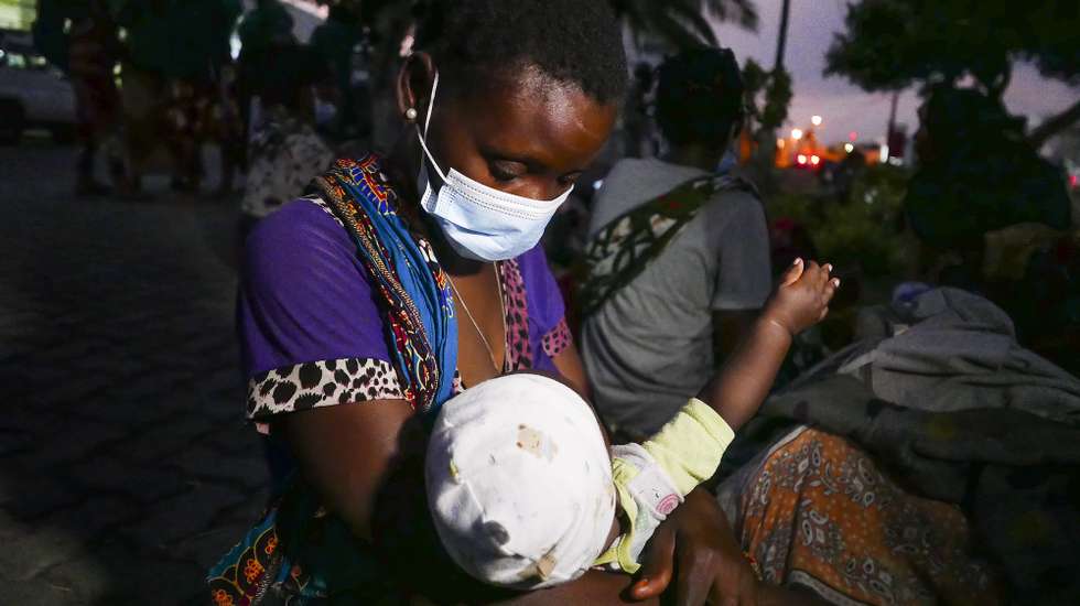 epa09107130 Tomazina Cassiano, a 29 years old woman displaced from Palma, who spent 6 days hidden in the forest with her four months old daughter Josefina Costa, arrives at Pemba Airport, Mozambique, 30 March 2021. Several boats, private and others, organized by Total and the authorities, have been transporting people to Palma since 28 March 2021. Among displace people are women in labour, adults and children shot, among other injuries, in a number that should already be over 2,000, but without official confirmation.  EPA/LUIS FONSECA