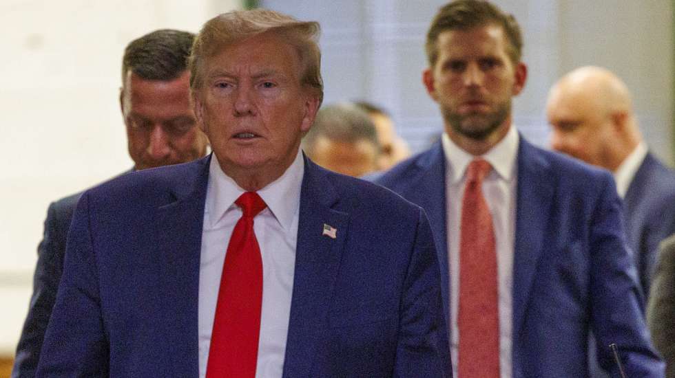 epa11016172 Former President of the United States, Donald J. Trump (L), exit the courtroom to speak to the press followed by his son, Eric Trump (R), during a break of his civil fraud court trial in New York, New York, USA, 07 December 2023. Trump, his adult sons and the Trump family business are facing a lawsuit by the State of New York accusing them of inflating the value of assets to get favorable loans from banks.  EPA/SARAH YENESEL