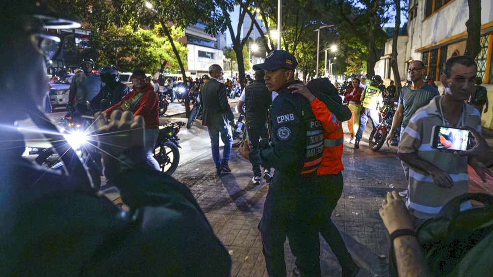 epa11504754 Members of Venezuelan security forces intervene in discussions between followers of people who are running for president of Venezuela and the candidate for re-election, Nicolas Maduro, in Caracas, Venezuela, 28 July 2024. Several dozen motorists who identified themselves as Chavistas arrived at a voting center in Caracas, where there were opposition witnesses and citizens waiting for the start of the scrutiny of the presidential elections which gave rise to a confrontation that ended with blows, as the police stood by and did not intervene to stop the fight.  EPA/HENRY CHIRINOS