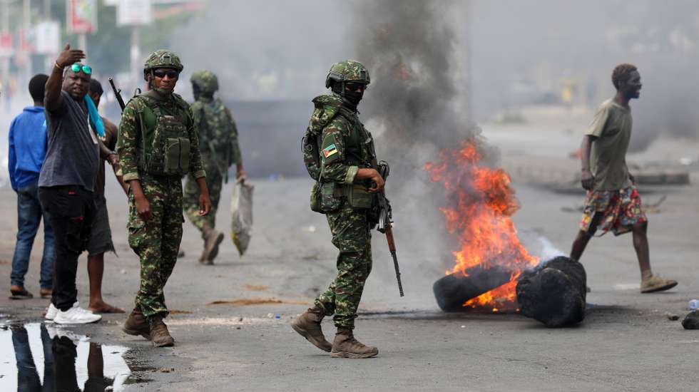 Military personnel pass by barricades and burning tires returned to the streets of Maputo this morning, with demonstrators contesting the process surrounding the October 9 general elections, with people clearing the way only for the military to pass through, Maputo, Mozambique, 06 December 2024. LUISA NHANTUMBO/LUSA