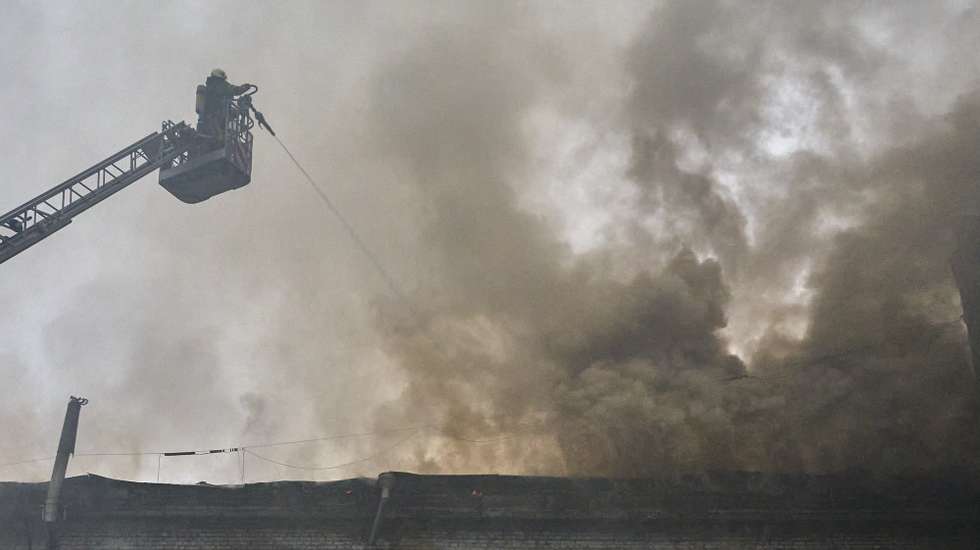 epa12001210 Ukrainian rescuers work at the site of a drone strike in Kharkiv, northeastern Ukraine, 31 March 2025, amid the Russian invasion. Overnight Russian drones hit Kharkiv, injuring at least three people and causing a fire in production and warehouse buildings, Kharkiv Regional Military Administration head Oleh Syniehubov reported on telegram.  EPA/SERGEY KOZLOV