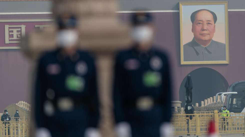 epa09814019 Security personal stand guard on Tiananmen Square for the closing session of the Chinese People's Political Consultative Conference (CPPCC) in front of the Great Hall of the People, in Beijing, China, 10 March 2022. China holds two major annual political meetings, The National People’s Congress (NPC) and the Chinese People's Political Consultative Conference (CPPCC) which run alongside and together known as 'Lianghui' or 'Two Sessions'.  EPA/ALEX PLAVEVSKI