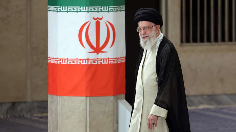 epa11458340 Iranian Supreme Leader Ayatollah Ali Khamenei arrives to cast his vote during the presidential election in Tehran, Iran, 05 July 2024. Iran holds the second round of the presidential election on 05 July 2024.  EPA/STR