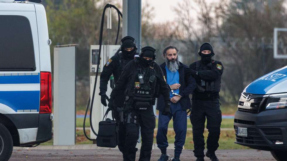 epa12516453 Defendant Taleb al-Abdulmohsen (C) is led to a police helicopter after the first day of his trial for murder in the 2024 Magdeburg Christmas market attack in Magdeburg, Germany, 10 November 2025. On 20 December 2024, Taleb al-Abdulmohsen drove a car at high speed into the open-air Christmas market, killing at least six people and injuring over 300.  EPA/JENS SCHLUETER  / POOL