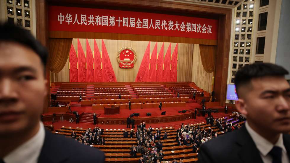 epa12796000 Delegates leave the hall as security officers stand guard after the opening ceremony of the Fourth Session of the 14th National People's Congress of China at the Great Hall of the People in Beijing, China, 05 March 2026. China's major annual political meetings, known as the 'Lianghui' or 'Two Sessions,' began on 04 March with the opening of the Chinese People's Political Consultative Conference (CPPCC), while the National People's Congress (NPC) opens on 05 March.  EPA/ANDRES MARTINEZ CASARES
