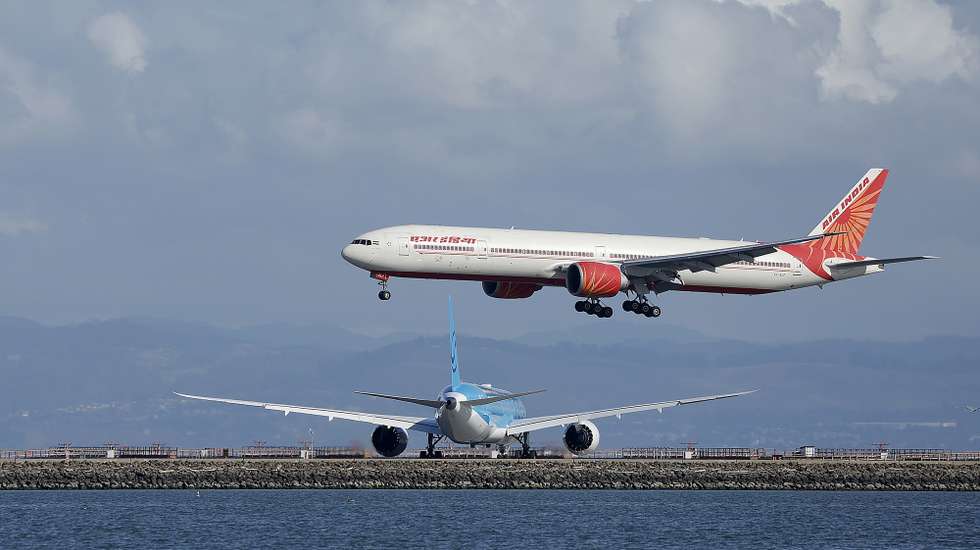 epa12527205 An Air India airlines lands at the San Francisco International Airport (SFO) as seen from Bayfront Park in Burlingame, California, USA, 14 November 2025. Officials warned it may take days for airports to get back up to speed despite President Donald Trump signing a bill to end the government shutdown on 12 November.  EPA/JOHN G. MABANGLO