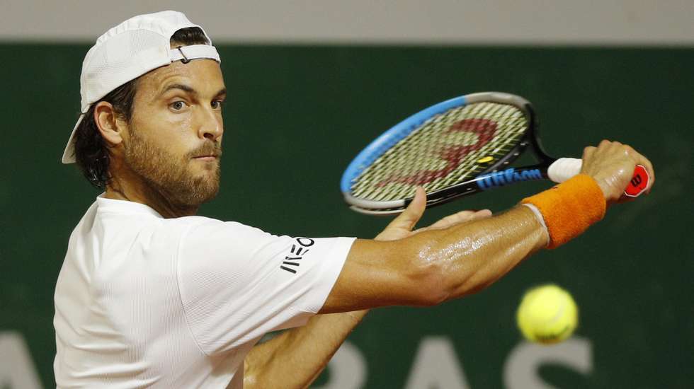 epa08706518 Joao Sousa of Portugal eyes the ball during his first round match against Andrej Martin of Slovakia at the French Open tennis tournament at Roland Garros in Paris, France, 29 September 2020.  EPA/YOAN VALAT