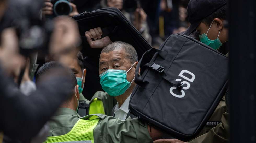 epa08997558 Media mogul Jimmy Lai (C) is escorted out of a Correctional Services Department vehicle and into the Court of Final Appeal in Hong Kong, China, 09 February 2021. Lai returned to court and has applied for bail after being accused of colluding with foreign forces under the national security law.  EPA/JEROME FAVRE